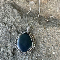 Black Beach Stone Necklace lying on the Rocks. Nature Necklace Bohemian necklace Bold necklace Beautiful necklace Sterling silver necklace Goddess necklace Sexy necklace Textured necklace Statement necklace Unique necklace  Cosmic necklace