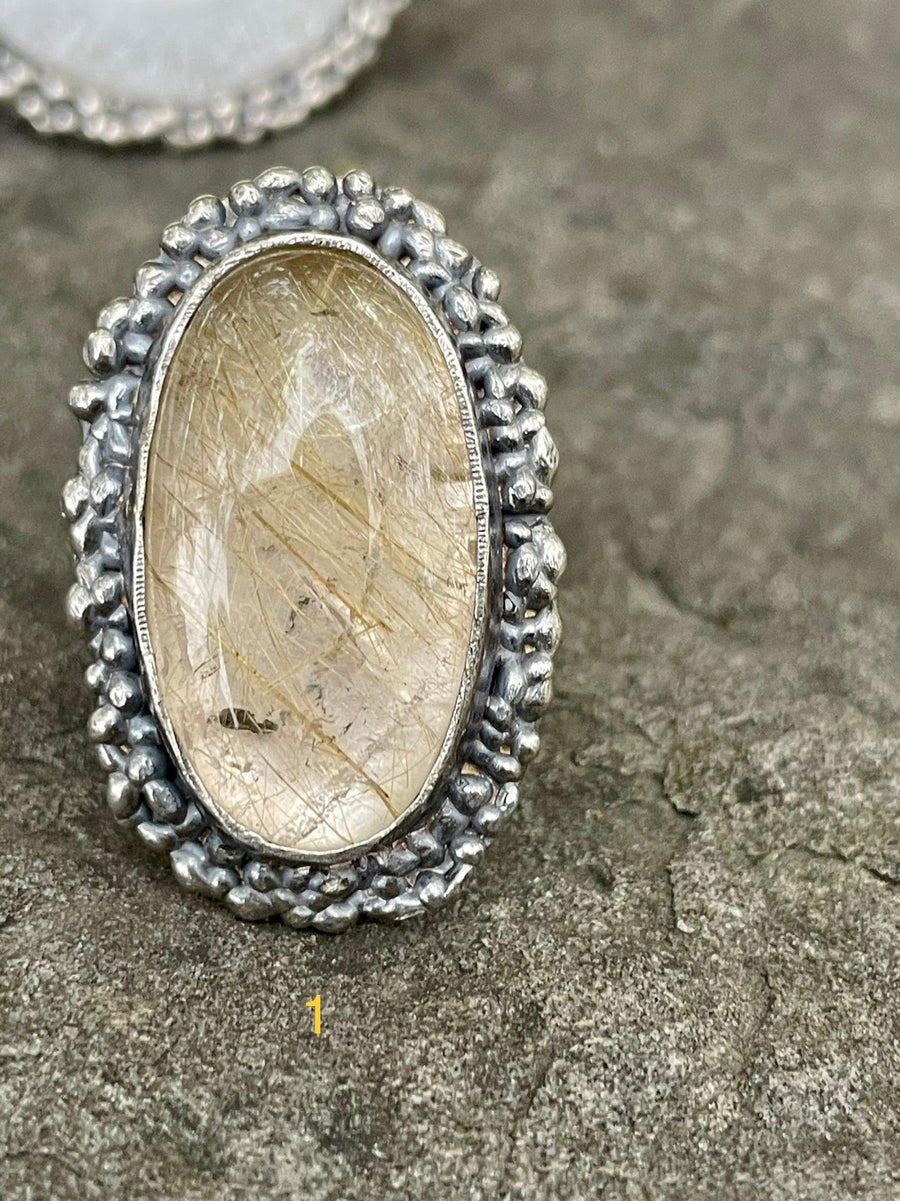 Grande Ring lying on a Stone. Grande Ring on finger. Textured ring Bohemian ring Statement ring Bold ring Large ring Sterling silver ring Unique ring Goddess ring Cosmic ring  Gemstone ring  Golden Rutile Ring Golden Stone Ring Quartz Ring