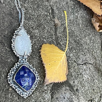Majestic Necklace lying on stone and leaf background side view. Bohemian necklace Bold necklace Beautiful necklace Sterling silver necklace Goddess necklace Sexy necklace Textured necklace Statement necklace Unique necklace Cosmic necklace Lapis Lazuli Necklace Quartz Druzy Necklace Blue Stone Necklace White Stone Necklace Blue and White Stone Necklace