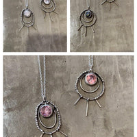 Shakti Large Oval Necklaces lying on concrete. Bohemian necklace Bold necklace Beautiful necklace Sterling silver necklace Goddess necklace Sexy necklace Textured necklace Statement necklace Unique necklace Cosmic necklace Cubic Zirconia Necklace Bling Necklace