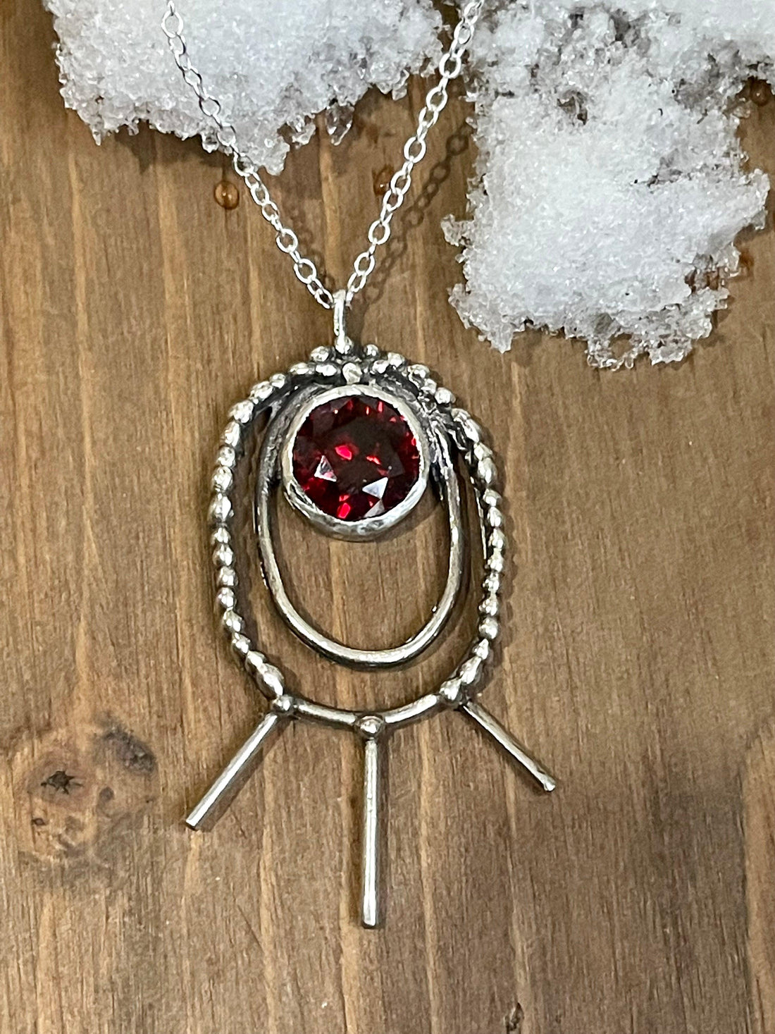 Shakti Large Oval Necklace in red. Shakti Large Oval Necklace lying on snow. Bohemian necklace Bold necklace Beautiful necklace Sterling silver necklace Goddess necklace Sexy necklace Textured necklace Statement necklace Unique necklace Cosmic necklace Cubic Zirconia Necklace Bling Necklace