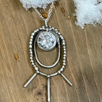 Shakti Large Oval Necklace in clear. Shakti Large Oval Necklace lying on snow. Bohemian necklace Bold necklace Beautiful necklace Sterling silver necklace Goddess necklace Sexy necklace Textured necklace Statement necklace Unique necklace Cosmic necklace Cubic Zirconia Necklace Bling Necklace