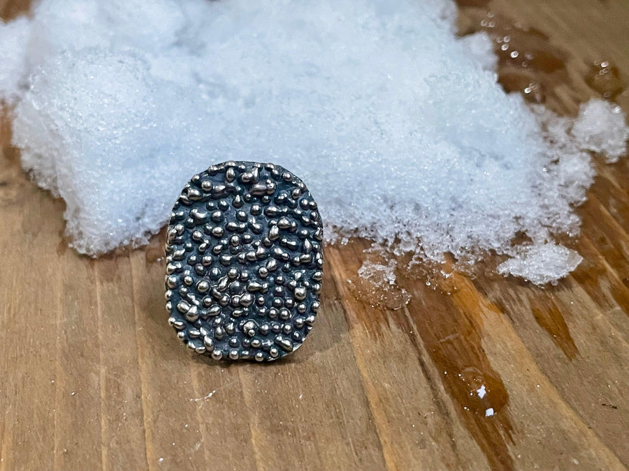 Shield Droplet Ring on wood.  Shield Droplet Ring on ice.   Textured ring Bohemian ring Statement ring Bold ring Large ring Sterling silver ring Unique ring Goddess ring Cosmic ring