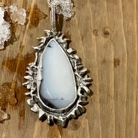 Snow White Necklace lying in wood. Bohemian necklace Bold necklace Beautiful necklace Sterling silver necklace Goddess necklace Sexy necklace Textured necklace Statement necklace Unique necklace  Cosmic necklace Dendritic Opal Necklace White Stone Necklace
